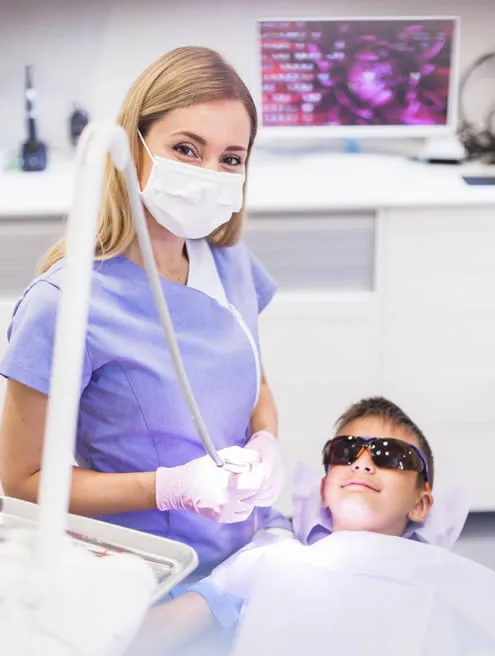 dental hygienist with boy at dental office